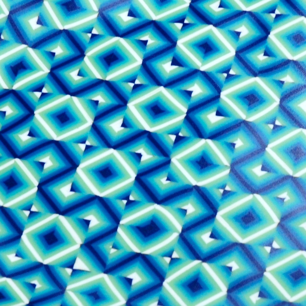 A close up showing a geometric pattern of intersecting squares with diagonal blue lines