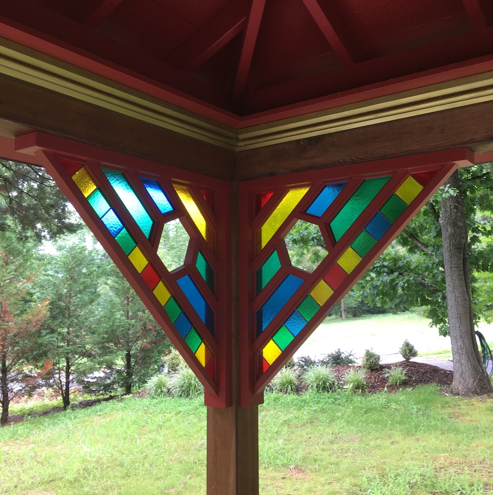 Rainbow colored glass panels inserted in a geometric support bracket