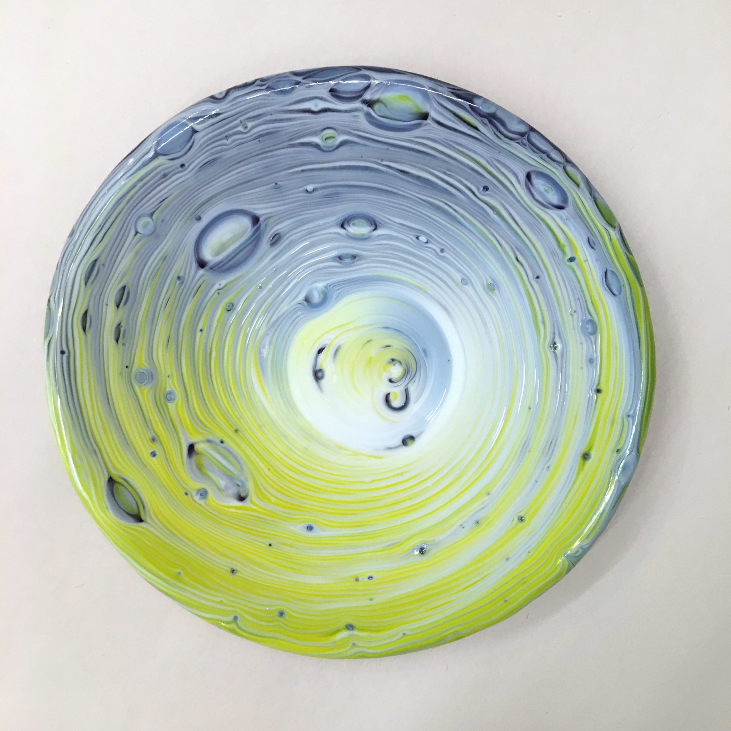Image of a swirling, bubbly, white, purple and yellow glass plate