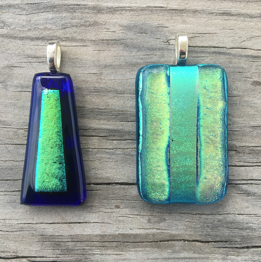 Two sparkling blue glass necklace pendants